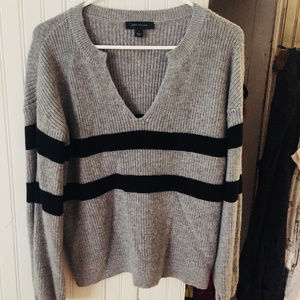 Grey sweater with cross-body black stripes